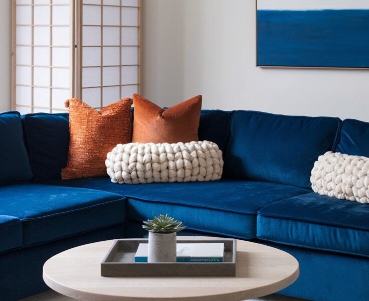Canape d angle en velours bleu avec coussins orange et paravent japonais